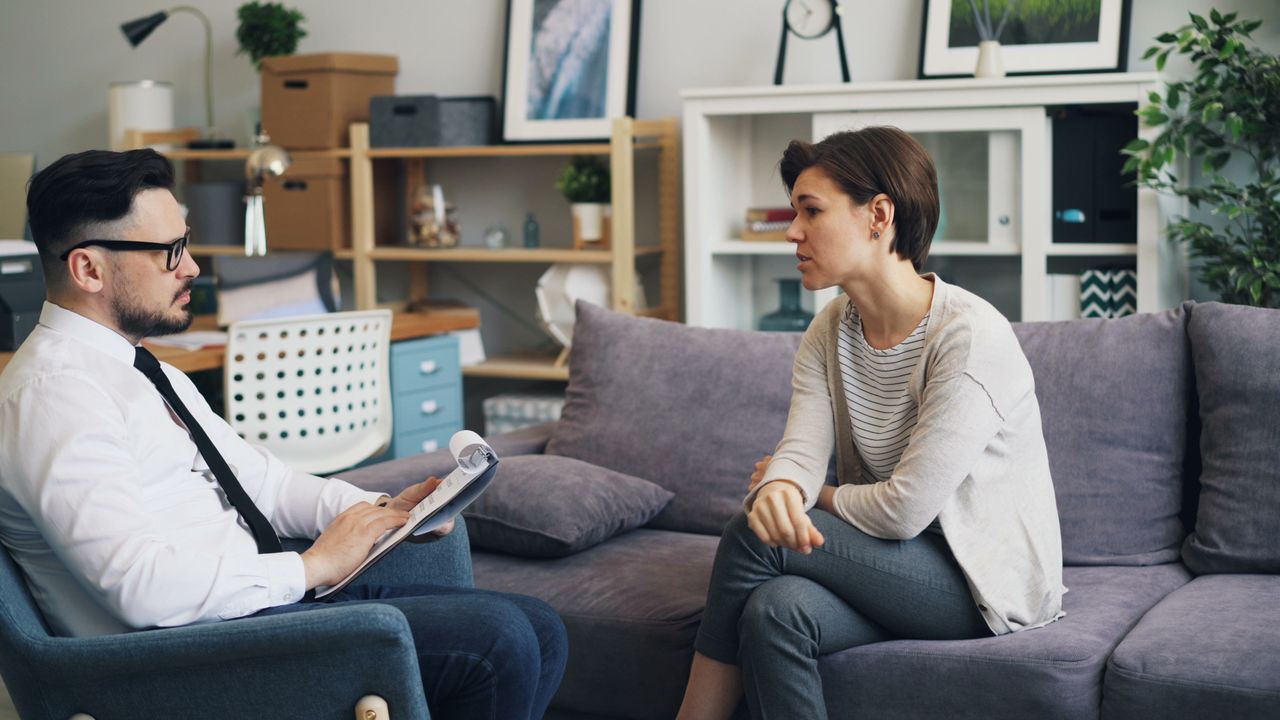 Mastering the First Impression: Your intriguing post title goes here A therapist consults with a client during a counseling session on a sofa in an office setting.