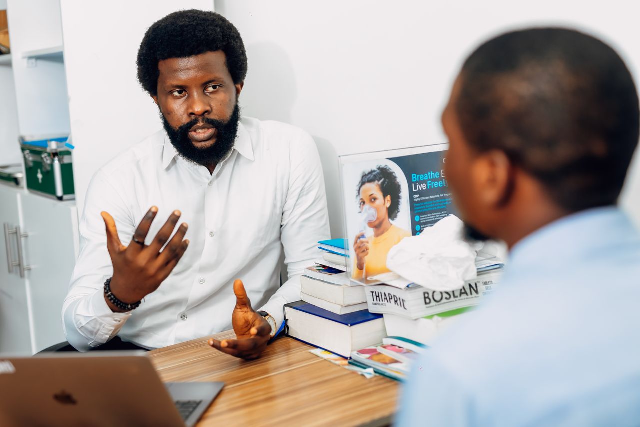 services-02 A doctor discusses health concerns with a patient at a medical office in Lagos, Nigeria.