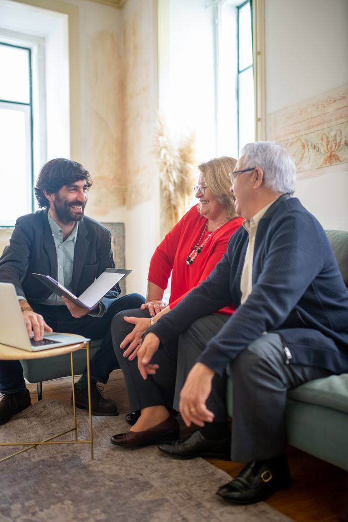 services-04 A professional business consultation with a senior couple and advisor indoors.